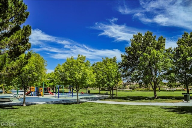 view of community featuring playground community and a lawn