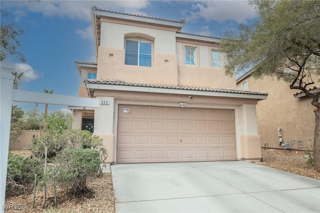 view of front of property with stucco siding, driveway, and a tiled roof