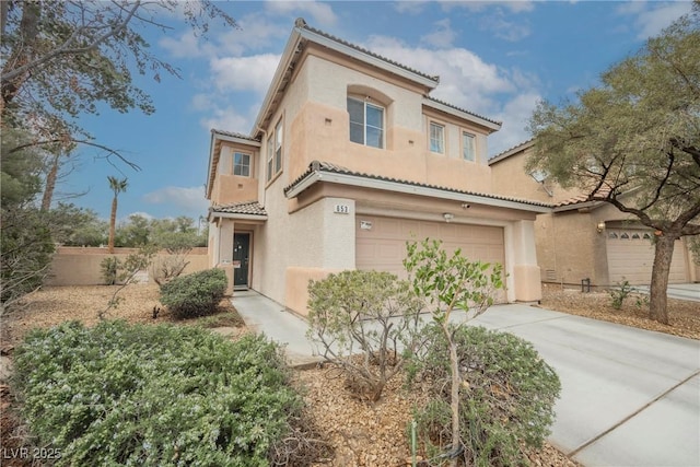 mediterranean / spanish-style home with a tile roof, driveway, and stucco siding