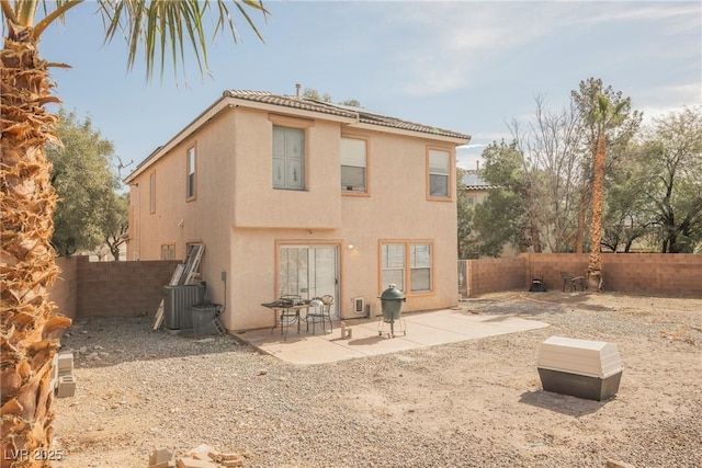 back of house with a patio, cooling unit, a fenced backyard, and stucco siding