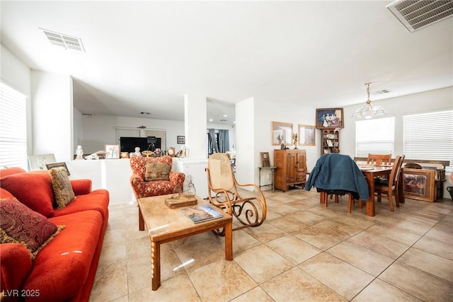 living area with light tile patterned floors and visible vents