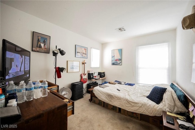 bedroom featuring light colored carpet and visible vents