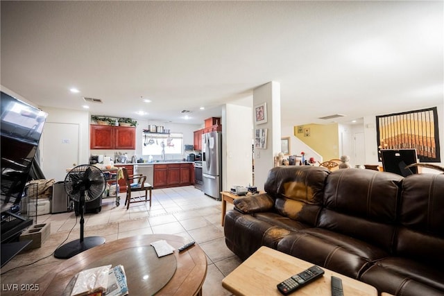 living area featuring light tile patterned flooring, recessed lighting, and visible vents