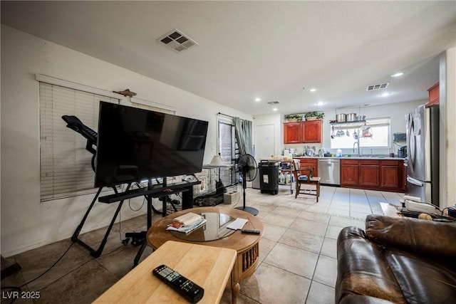 living area with recessed lighting, visible vents, and light tile patterned flooring