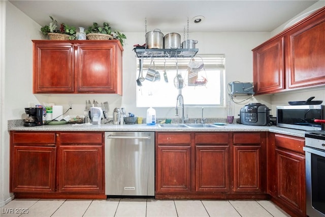 kitchen with a sink, light countertops, dark brown cabinets, and stainless steel appliances