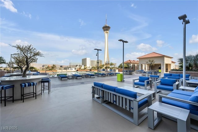 view of patio featuring outdoor lounge area, a city view, and outdoor dry bar