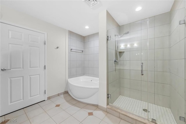 full bath featuring visible vents, baseboards, a shower stall, a garden tub, and tile patterned floors