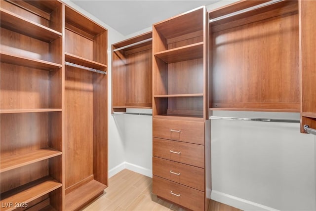 walk in closet featuring light wood finished floors