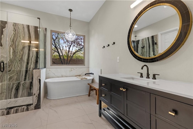 full bathroom featuring a freestanding tub, a notable chandelier, marble finish floor, a marble finish shower, and vanity