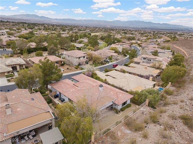 birds eye view of property with a mountain view and a residential view