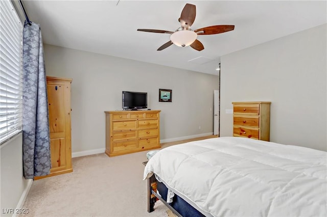 bedroom featuring baseboards, light carpet, and ceiling fan