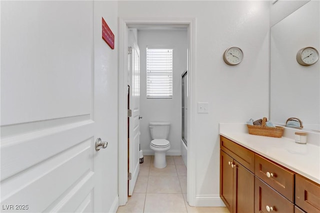 full bathroom with tile patterned floors, toilet, baseboards, bath / shower combo with glass door, and vanity