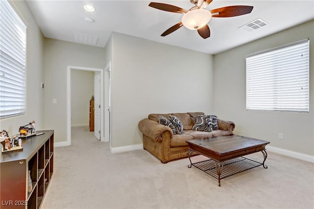 living room featuring visible vents, light colored carpet, and baseboards