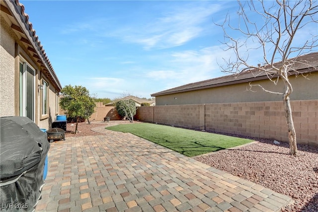 view of patio / terrace featuring a grill and a fenced backyard