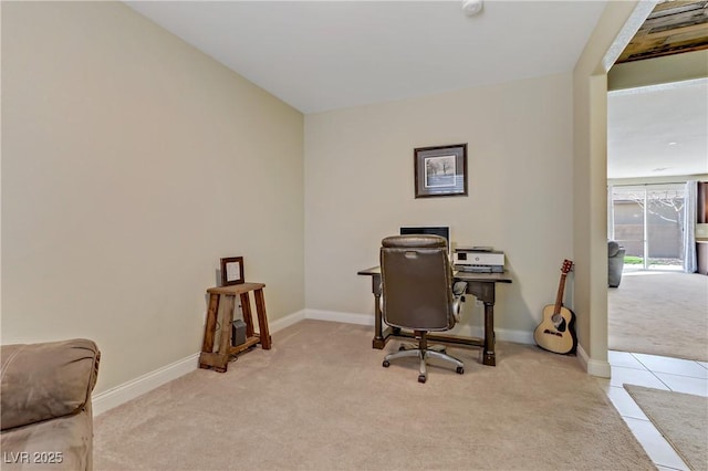 office area with light tile patterned flooring, light colored carpet, and baseboards