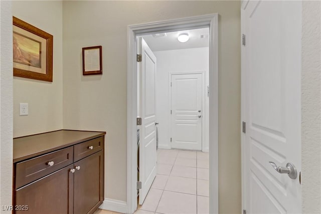 corridor featuring light tile patterned floors