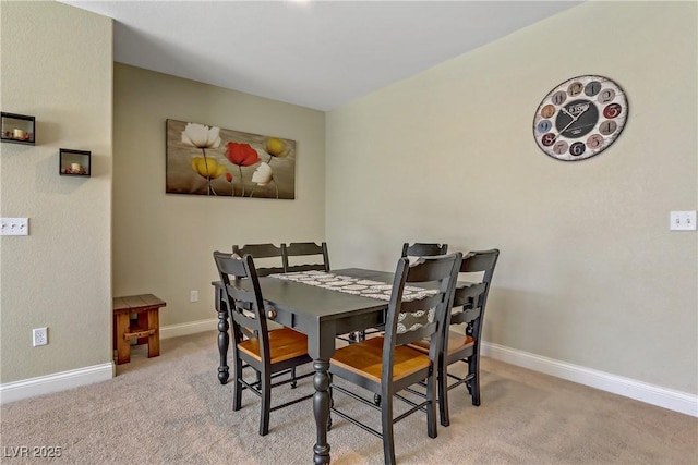 dining area with baseboards and carpet flooring