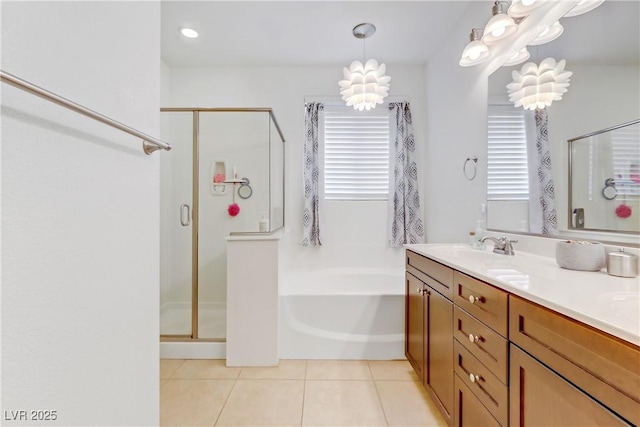 full bath with tile patterned floors, a stall shower, vanity, and a garden tub