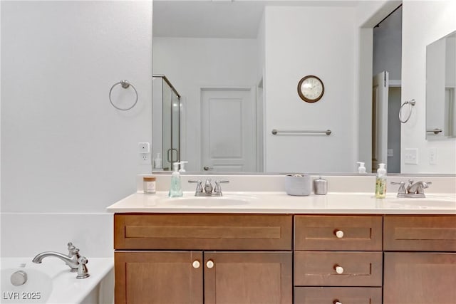 bathroom featuring a sink, a shower with shower door, a bath, and double vanity