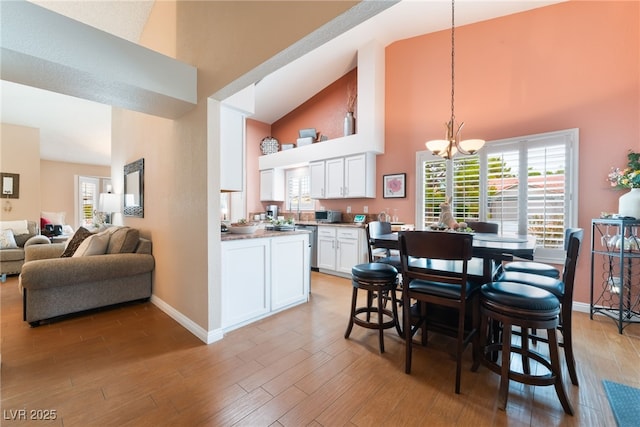 dining room featuring a chandelier, light wood-style flooring, and a healthy amount of sunlight