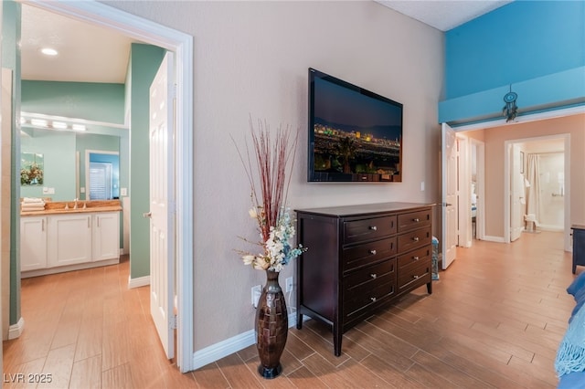 hall with baseboards and light wood-type flooring