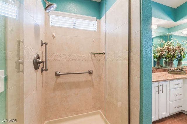 full bathroom with vanity and a shower stall