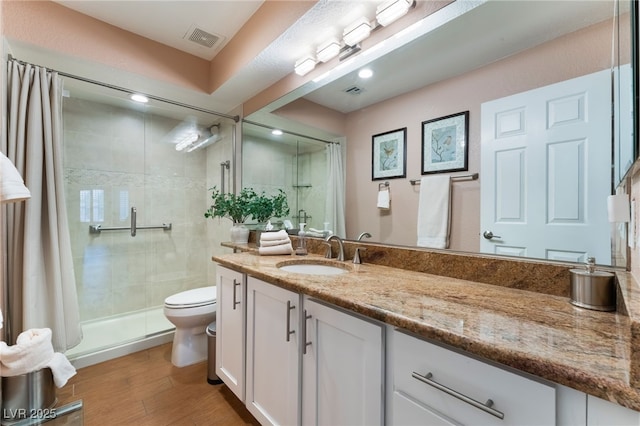 full bath featuring visible vents, a stall shower, toilet, and wood finished floors