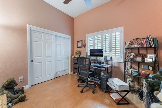 office area featuring wood finished floors, baseboards, and ceiling fan