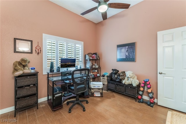 office featuring baseboards, a ceiling fan, and wood tiled floor