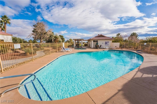 community pool featuring a patio area and fence