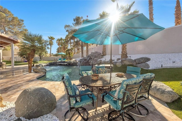 view of patio / terrace with outdoor dining area, a fenced in pool, and fence private yard