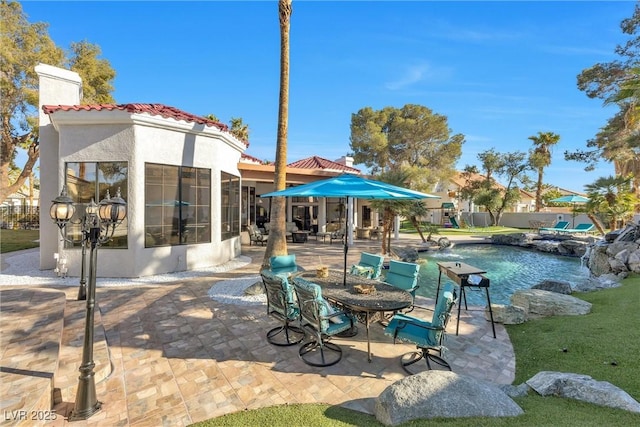 view of patio / terrace with a fenced in pool and a sunroom