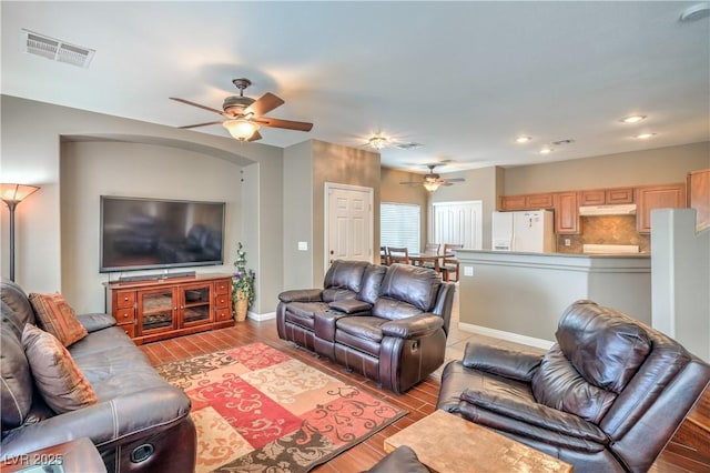 living area with visible vents, a ceiling fan, wood finished floors, recessed lighting, and baseboards