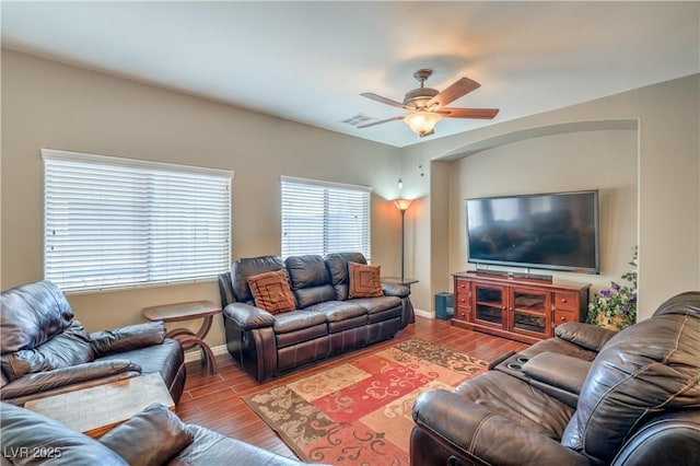 living room with visible vents, baseboards, ceiling fan, and wood finished floors