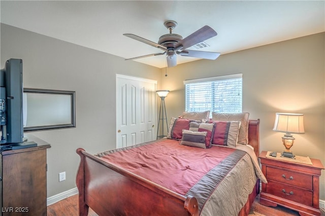 bedroom with wood finished floors, baseboards, and ceiling fan