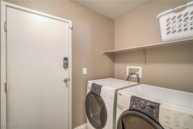 laundry room featuring separate washer and dryer and laundry area