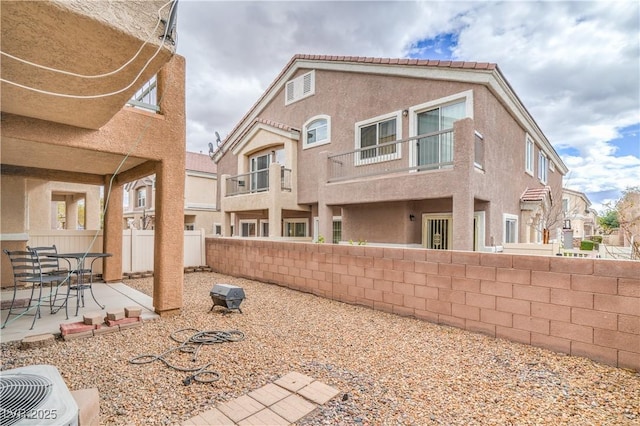 back of house with a patio area, central air condition unit, stucco siding, and a fenced backyard