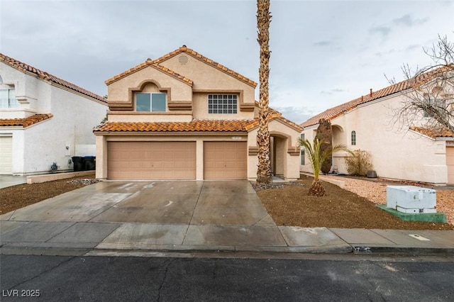 mediterranean / spanish-style house with stucco siding, a garage, driveway, and a tiled roof