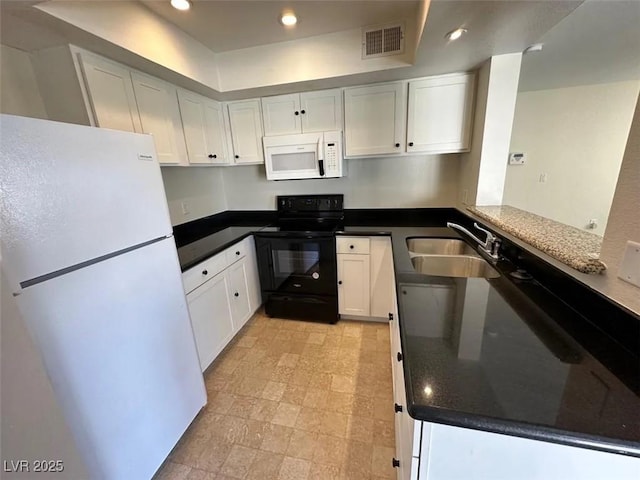 kitchen featuring visible vents, recessed lighting, white appliances, white cabinetry, and a sink