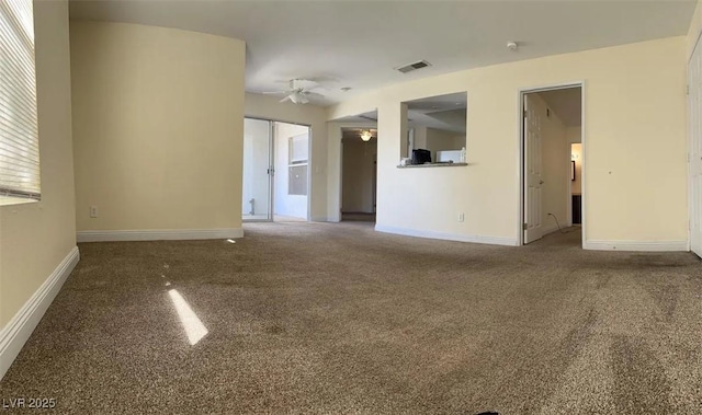 spare room featuring ceiling fan, carpet, visible vents, and baseboards