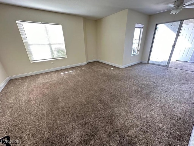 spare room with carpet flooring, baseboards, and ceiling fan