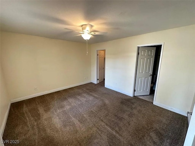 empty room featuring ceiling fan, baseboards, and dark colored carpet