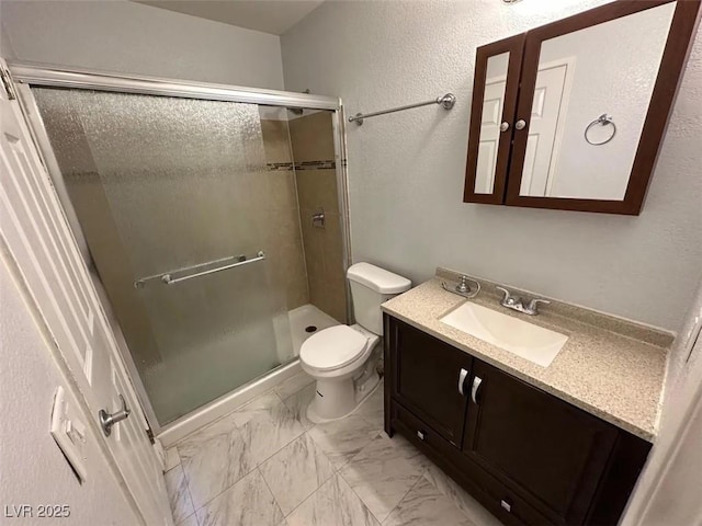 full bathroom with vanity, a shower stall, toilet, and marble finish floor