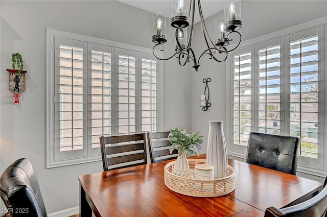 dining space with an inviting chandelier