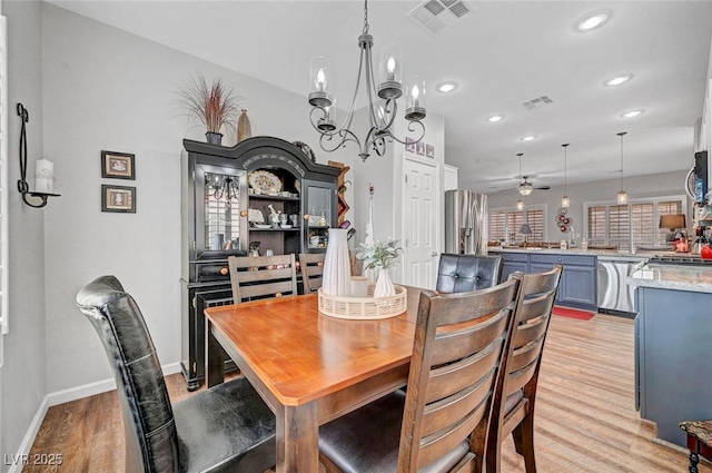 dining space with light wood-style flooring, recessed lighting, visible vents, and baseboards