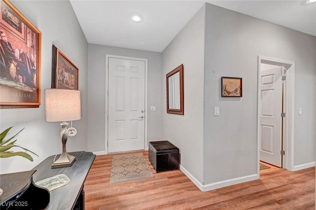 entryway featuring baseboards and light wood finished floors