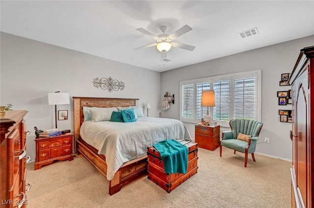 bedroom with a ceiling fan, visible vents, baseboards, refrigerator, and light carpet