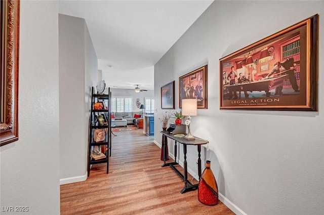 hall with wood finished floors and baseboards