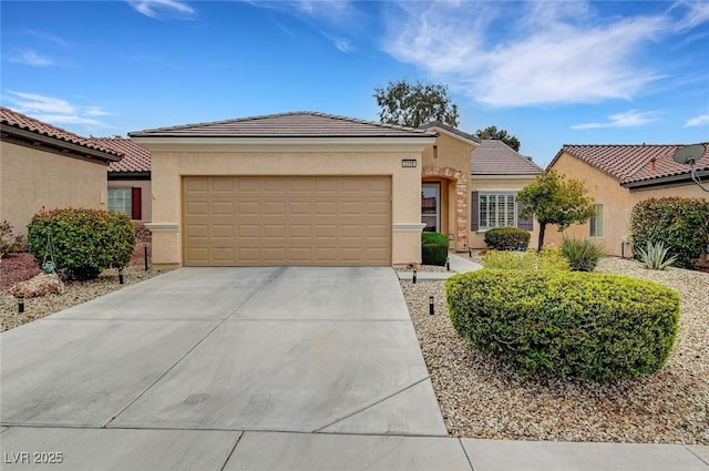 view of front of home featuring a tile roof, concrete driveway, a garage, and stucco siding