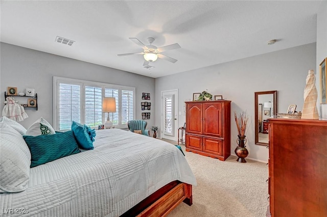 carpeted bedroom featuring a ceiling fan, visible vents, and baseboards